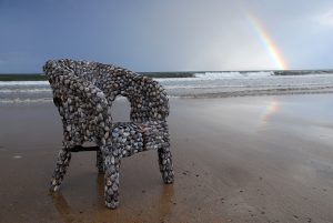 Blott Kerr-Wilson, 'Chairs', detail of a mussel shell chair photographed on a beach with a rainbow
